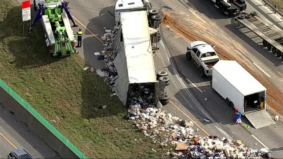 Massive 18 Wheeler Overturns on I 20 in Dallas, Spills Trash Across Highway