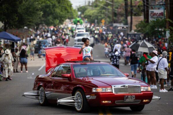 Juneteenth parade participants wave to attendees along Chicon Street on Thursday, June 19, 2025, in Austin.