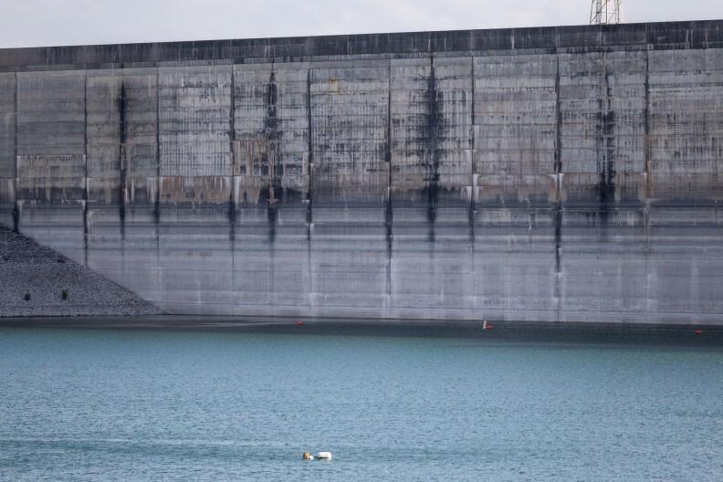 Low water levels at Lake Travis reveal various water level lines on Mansfield Dam on June 16, 2024.