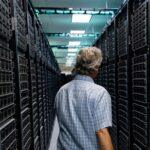 Tommy Minyard, with the Texas Advanced Computing Center, walks down an aisle of the data center on Thursday, March 26, 2026, in Austin, Texas.