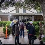 Clients line up for a meal service on Dec. 4, 2024, at Sunrise Homeless Navigation Center.