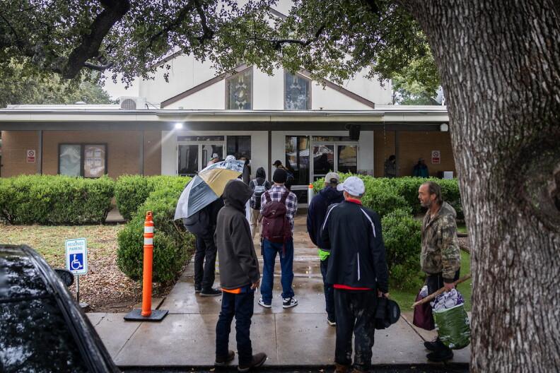 Clients line up for a meal service on Dec. 4, 2024, at Sunrise Homeless Navigation Center.